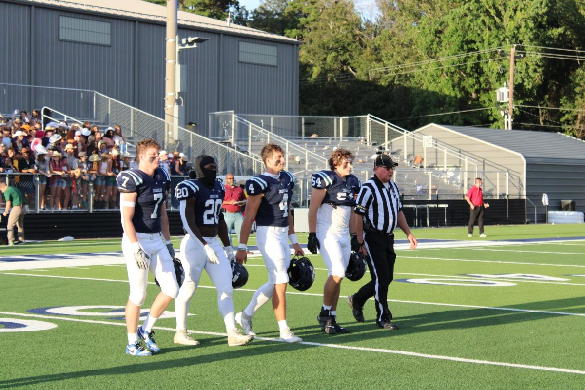 Captains Cooper Jones, Preston Davis, Walker White, and Andrew Lord walk to centerfield for the coin toss.
