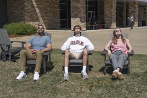 Multimedia students and teachers prepare their eyes for the solar eclipse. During the total darkness, solar eclipse glasses are not needed.